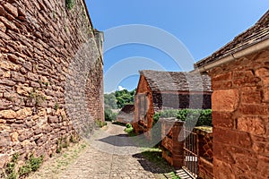 Ordinary medieval settlement outside perimeter of second protective red-stone walls andÃÂ  cobblestone pavement leading to valley